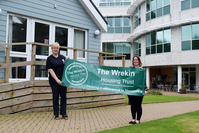 Laura handing over the WHT banners to Debbie from Broseley Festival