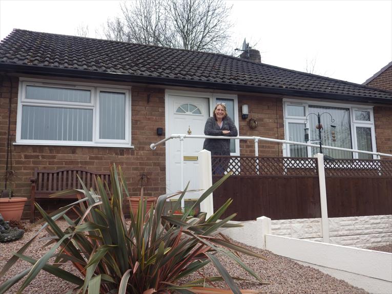 Julie Jones outside her bungalow