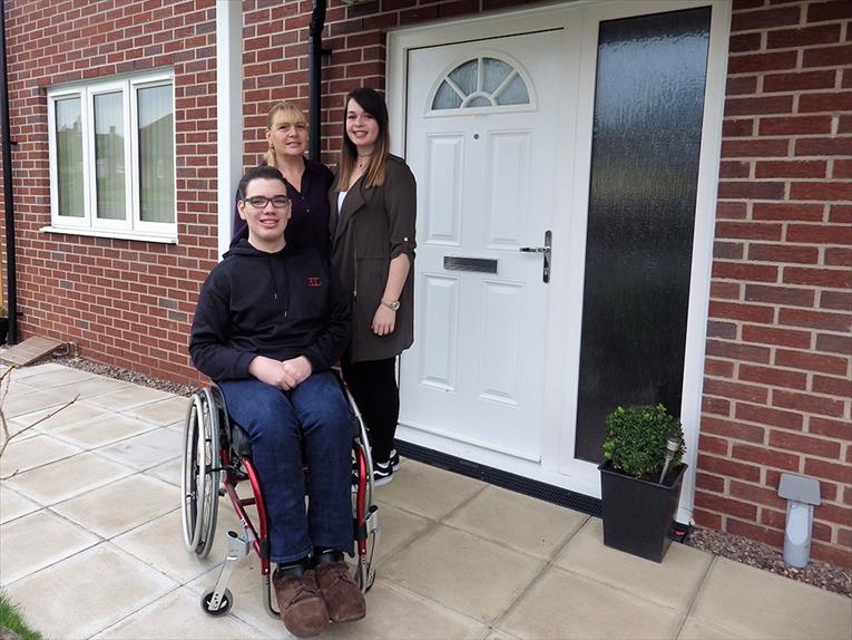 Lewis with family outside home in Newport